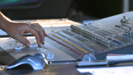 Sound-engineer-tweaks-audio-control-panel,-close-up