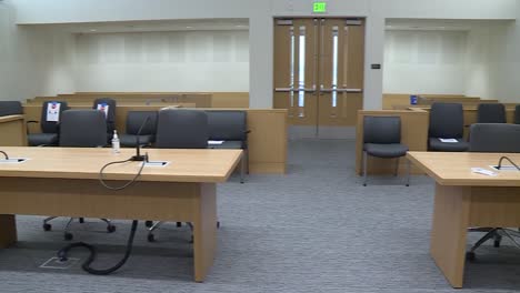 INSIDE-AN-EMPTY-COURT-ROOM-SHOWING-LAWYERS-DESKS