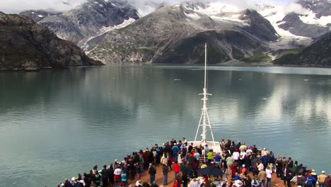 Tourists-on-the-bow-of-a-cruise-ship-in-Glacier-Bay-National-Park-Alaska,-enjoying-the-landscape