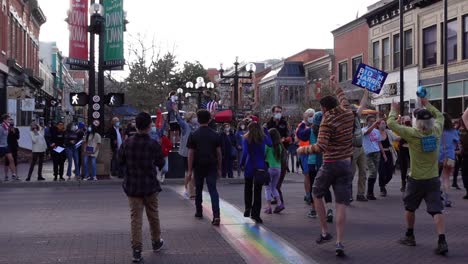 People-celebrating-Joe-Biden's-election-victory-in-the-streets-of-Boulder,-Colorado