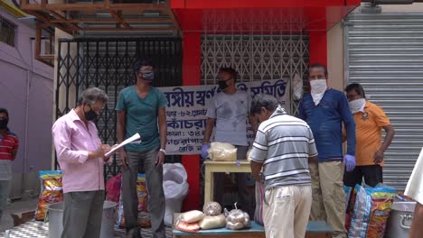 Asian-People-donating-and-distributing-emergency-food-ration-to-poor-people-in-India-during-Covid-19-coronavirus-quarantine