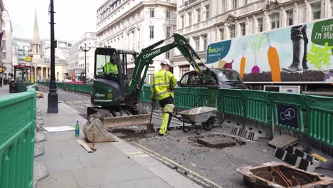 Mini-Digger-working-in-famous-London-street-to-create-wider-pavements-and-cycle-lane