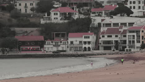 Family-Enjoying-Their-Time-Alone-In-The-Beach-At-Sao-Martinho-do-Porto-Portugal---wide-shot