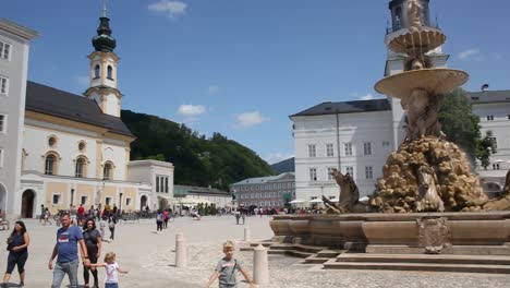Residence-Square-with-fountain-in-Salzburg-summertime-panorama,-many-people