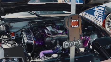 Arc-Shot-of-Modified-Purple-Engine-of-a-Mazda-Miata-at-Car-Show