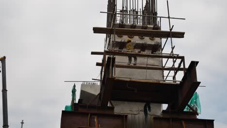 Construction-workers-installing-the-pre-stress-cable-and-tendons-at-the-height-at-the-construction-site