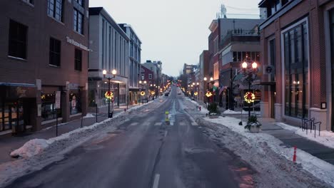 Low-camera-glide-above-street-in-USA,-plowed-after-snowstorm