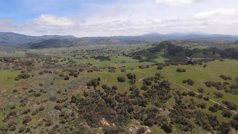 SANTA-YSABEL,-CA---Circa-September,-2020---Aerial-view-chasing-a-black-helicopter-over-the-hills-near-Santa-Ysabel,-California