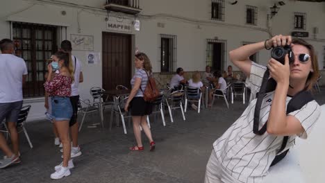 A-tourist-takes-photographs-of-the-beautiful-town-of-Setenil-de-las-Bodegas,-Spain