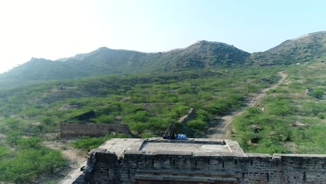 Bhuj-Fort-Stock-Footage,-View-from-drone-to-happy-young-family,-fish-eye-view-from-Kumbhalgarh-fort-walls,-Rajasthan,-India