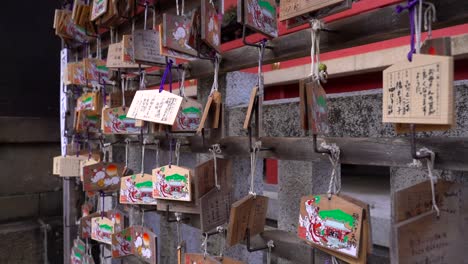 Slow-rotating-view-around-typical-wishing-cards-inside-Japanese-temple-grounds