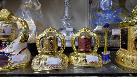 Slow-motion-shot-of-buddhist-worship-objects-in-store-in-Taiwan---lateral-tracking
