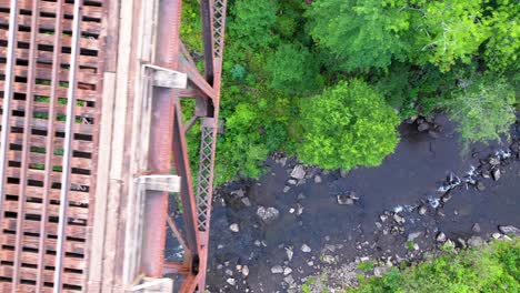 A-moving-aerial-shot-of-the-forest-and-river-around-the-Onawa-Trestle-in-Maine
