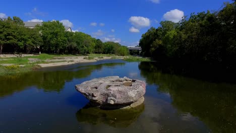 The-Brushy-Creek-Crossing-at-The-Round-Rock,-a-round-table-top-rock-in-the-middle-of-the-crossing,and-to-this-day-the-limestone-bottom-has-ruts-from-the-wagon-wheels-cut-into-it