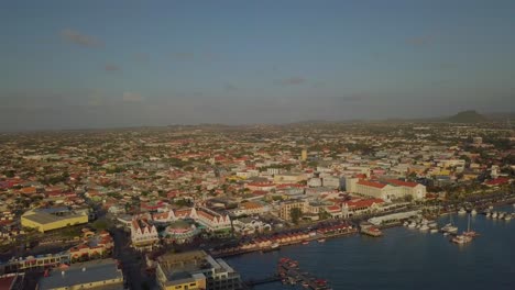 Aerial-zoom-view-of-the-beautiful-marina-and-busy-streets-in-the-city-Oranjestad-of-Aruba-4K