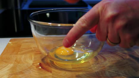 Cracking-3-fresh-eggs-into-a-glass-bowl