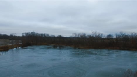 Drone-flying-over-a-partially-frozen-lake-that-has-very-unique-ice-formations-on-it