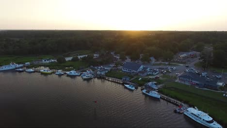 Flying-backwards-away-from-downtown-Calabash-NC-over-the-river-at-sunset