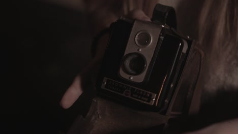Girl's-hands-opens-Box-Brownie-leather-camera-case-and-reveals-to-camera