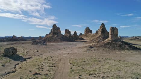 Low-aerial-view-moving-quickly-toward-the-Trona-Pinnacles-rock-formations-on-a-sunny-morning