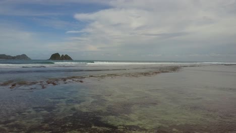 A-remote-surf-beach-at-Pantai-Selong-Belanak,-Lombok,-Aerial-shots-during-day-light