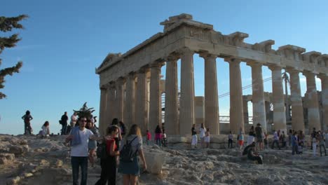 Tourists-enjoying-the-Parthenon-Temple-at-Acropolis-hill,-Athens,-Greece