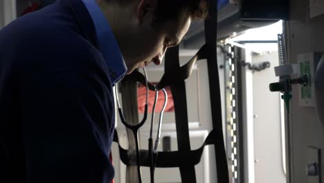 Emergency-medical-technician-prepares-medic-gear-inside-an-ambulance-to-be-ready-for-emergency-response