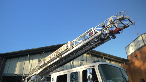 Fire-engine-sits-shiny-outside-of-a-fire-station-in-the-early-morning-sunlight