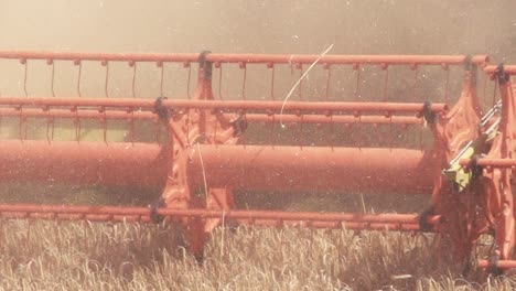 Slow-motion-of-a-harvester-harvesting-wheat-on-a-sunny-day