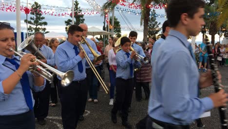 Christian-Religious-Festive-Celebration-procession-in-honor-of-saint-John-The-Baptist,-band-playing-parade-and-houndreds-of-people-walk-while-praying