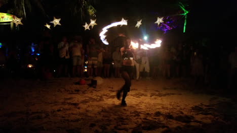 Female-variety-artist-performing-fire-show-on-the-beach-in-the-dark