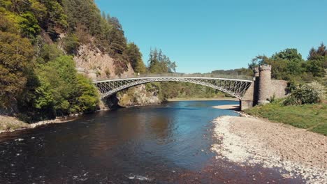 Drone-shot-of-the-old-disused-Craigellachie-road-Bridge-over-the-River-Spey-at-Craigelachie,-Arbelour,-Moray,-Scotland,-UK