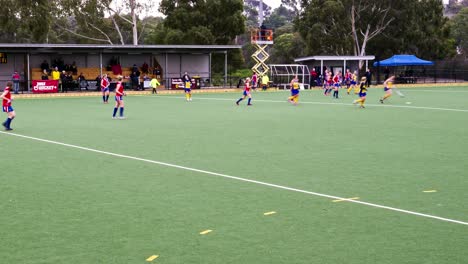 Zoom-out-timelapse-of-a-women's-premier-league-field-hockey-match-in-front-of-a-crowd-at-Elgar-Park