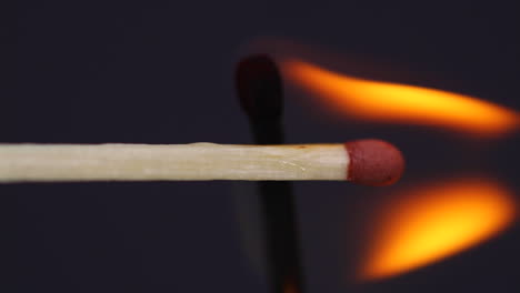 Ignition-matches-close-up-macro-shot-captured-in-front-of-black-background-in-slow-motion-at-60-fps