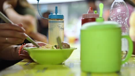 Shot-of-someone-eating-their-indonesian-food-and-playing-with-their-noodles