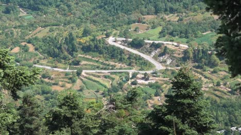 Aerial-view-of-winding-mountain-road-with-cars-driving-on-it