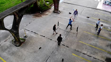 Aerial-video-of-group-of-friends-playing-soccer-tennis-with-a-net