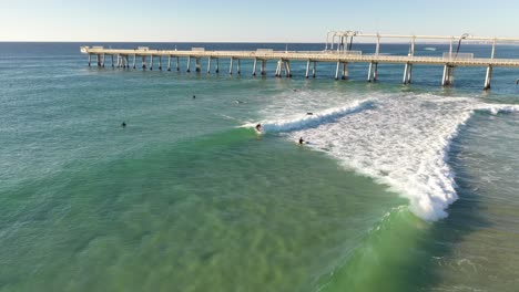 Aerial-view-of-the-ocean-and-surfers-enjoying-a-beautiful-warm-summer-day-on-the-Gold-Coast
