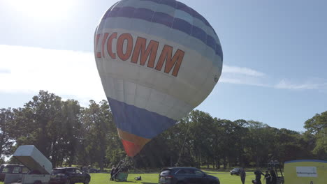 Team-of-hot-air-balloon-engineers-erect-inflate-their-balloons-for-a-tethered-display-at-a-Hot-Air-Balloon-festival