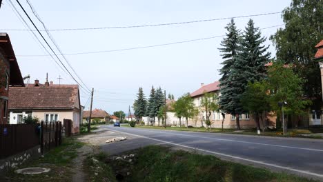 Tilt-up-shot-of-the-main-road-crossing-Lazarea,-Romania,-on-a-summer-day