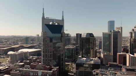 Circling-aerial-view-of-the-AT-T-building-in-downtown-Nashville,-Tennessee-on-a-clear,-fall-day