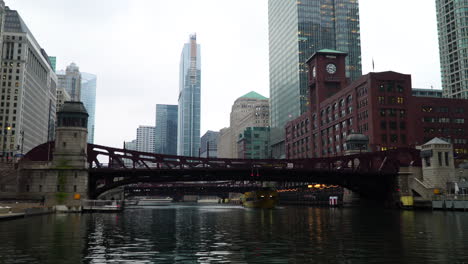 Chicago-water-taxi-passing-underneath-Clark-Street-Bridge-on-cloudy-day