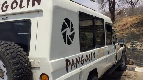 Pangolin-safari-truck-at-the-Botswana-Namibia-border-crossing,-pan-R
