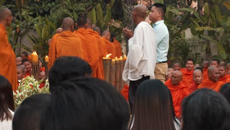 Exterior-Medium-Slow-Motion-Shot-of-Monks-Walking-in-Line-at-Ceremony-in-Evening