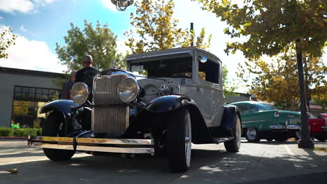 Restored-vintage-Model-T-roadster-with-exposed-engine-at-car-show,-slow-motion