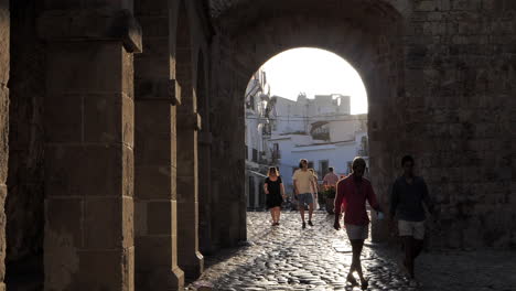 People-Walking-Dalt-Vila-Fort-Gate,-Eivissa-during-Corona-Crisis-SLOMO