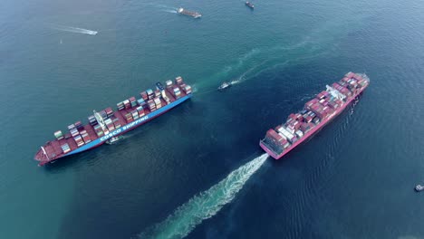 Two-mega-Container-Ships-heading-in-opposite-directions-in-Hong-Kong-bay,-Aerial-view
