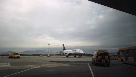 Arriving-Lufthansa-airplane-taxis-to-airport-terminal-in-Graz,-Austria