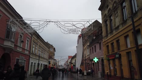 Brasov,-Romania---7-December-2019-:-People-walking-on-the-Old-Square-on-day-time,-Christmas-Fair-in-Brasov-,-Winter-Season,-Christmas-decorations