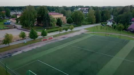 Aerial-view-dolly-in-of-Smiltenes-High-School-football-field,-Latvia